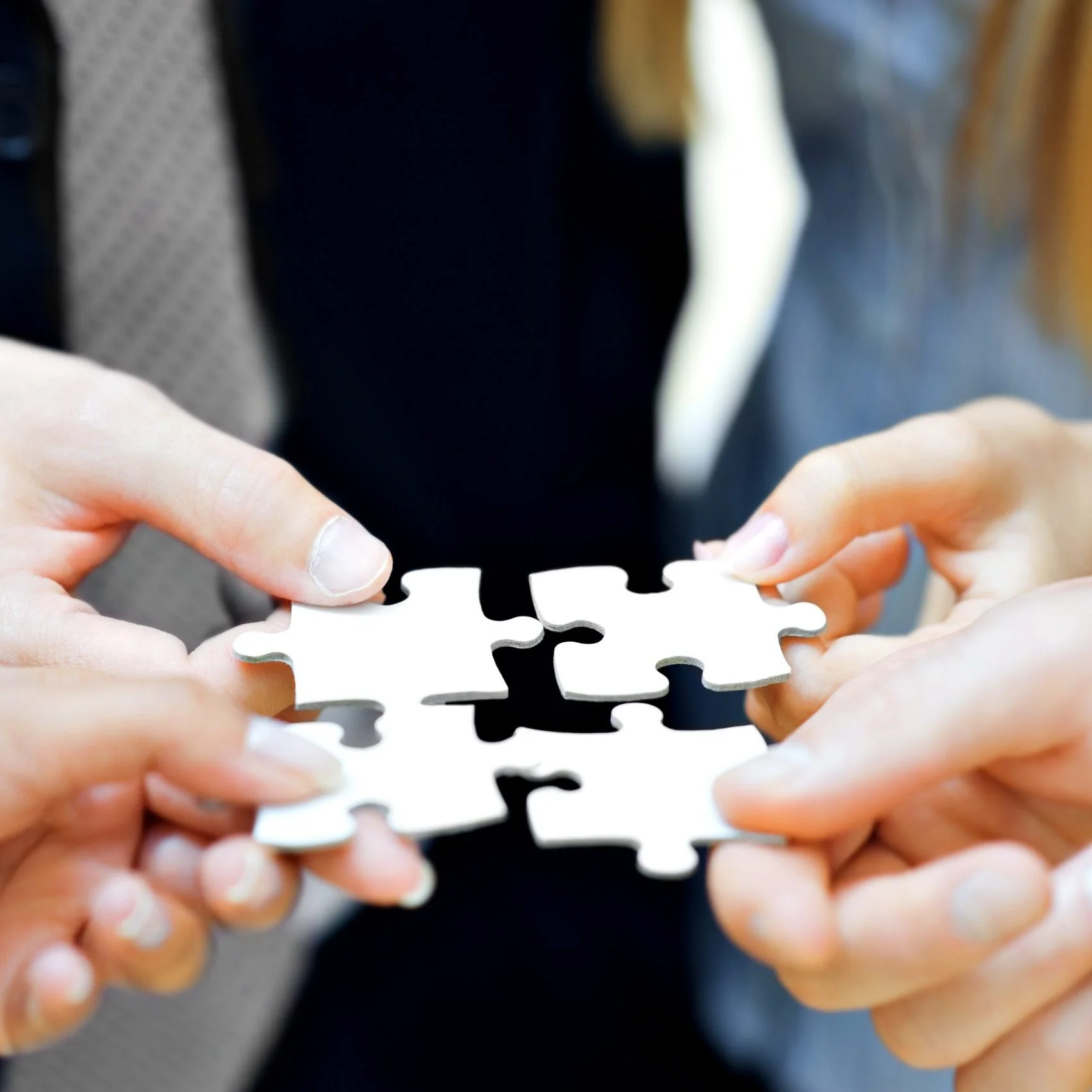 iStock-183048290-scaled-e1593026458182 4 people holding puzzle pieces together